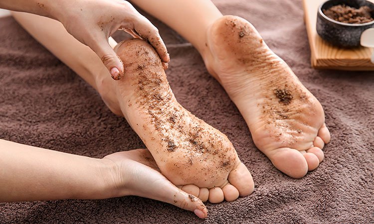 Young woman undergoing treatment with body scrub in spa salon